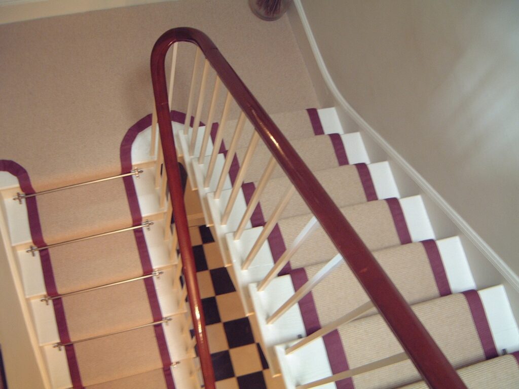 Hardwearing natural fibre flooring on a winding staircase supplied and fitted by Parsons Flooring